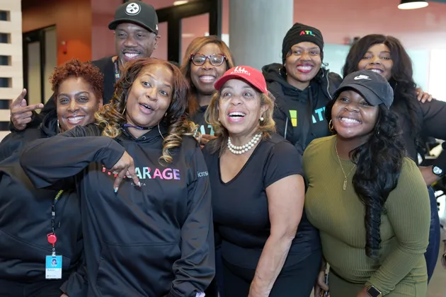 A group of smiling people pose for a photo.